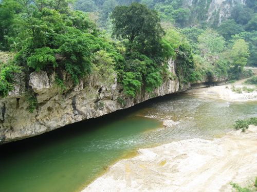 Những vách núi sừng sững như tạc vào lòng sông.