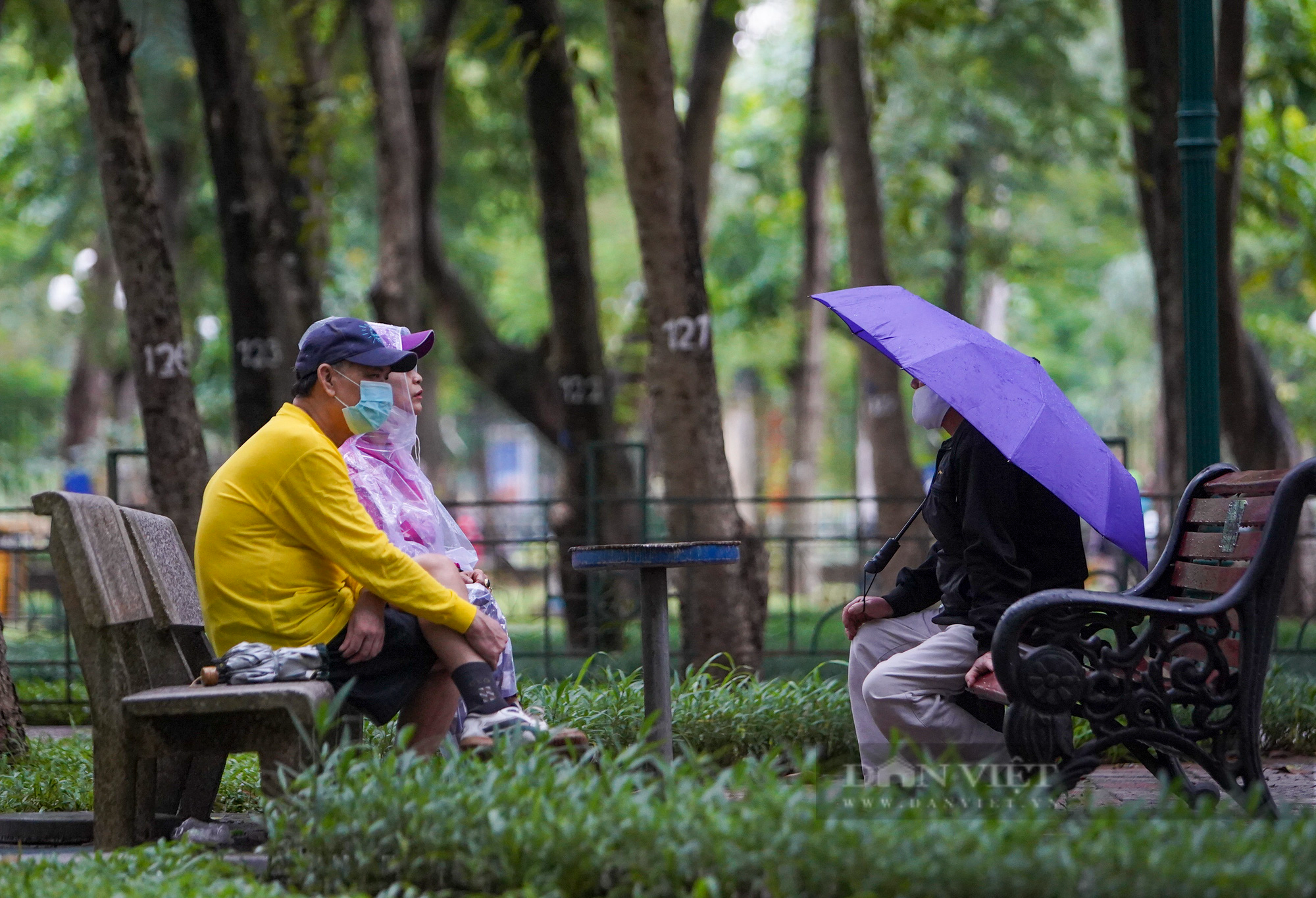 Hà Nội: Bất chấp mưa phùn, gió bấc, người dân mặc áo mưa ra công viên tập thể dục ngày đầu được mở lại - Ảnh 9.