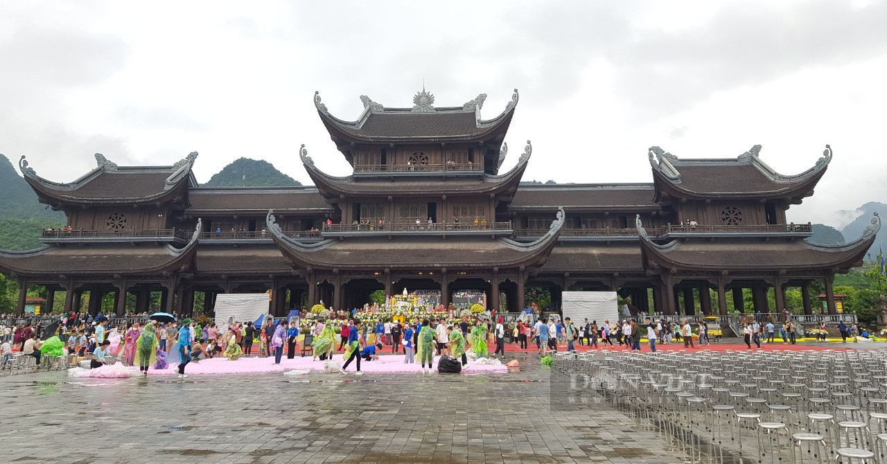 People wearing rain gear attend the Buddha’s birthday celebration at Tam Chuc pagoda