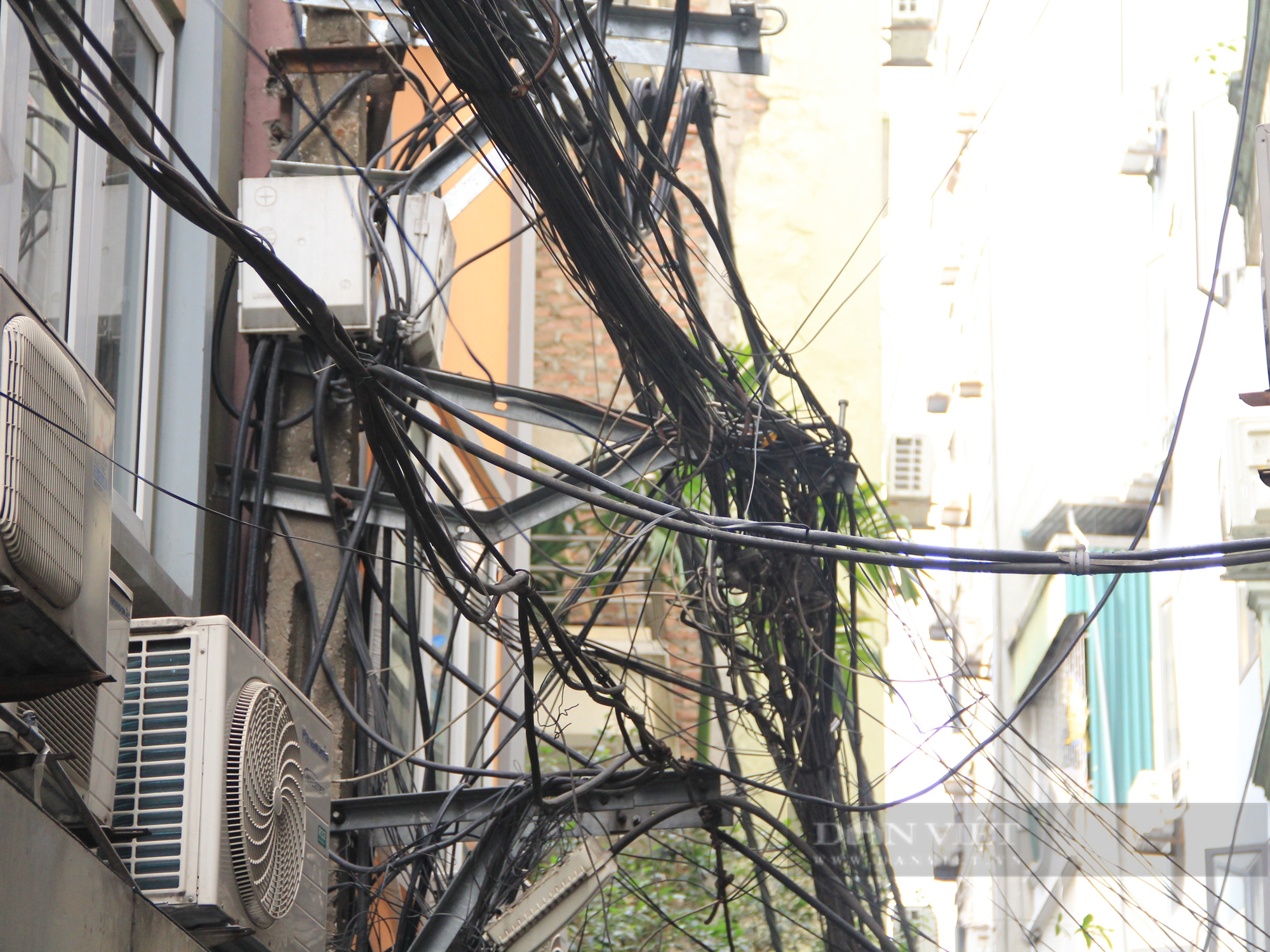 Nhiều tuyến phố ở Hà Nội: Dây điện, cáp viễn thông chằng chịt, “giăng bẫy” người dân - Ảnh 7.
