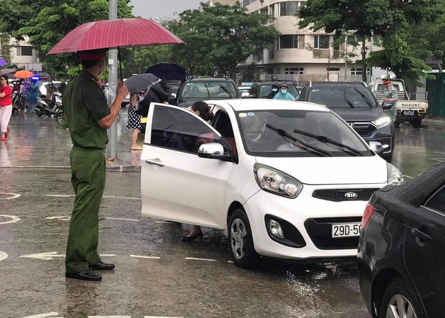 Thi vào lớp 10 ở Hà Nội sáng 13/6: Mưa như trút, thí sinh ướt nhẹp, vất vả vào điểm thi  - Ảnh 7.