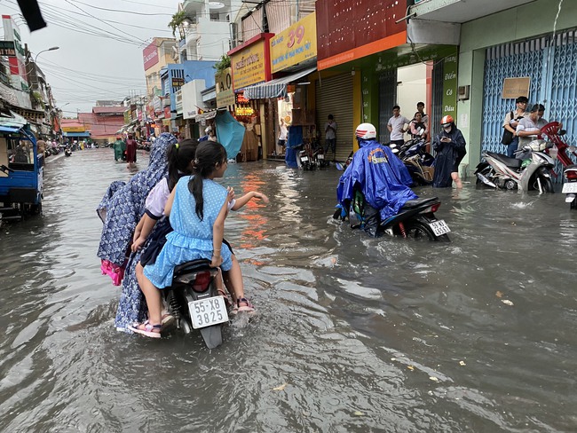 Người dân TP.HCM vật vã dưới trời mưa lớn, nhiều nơi đã ngập - Ảnh 3.