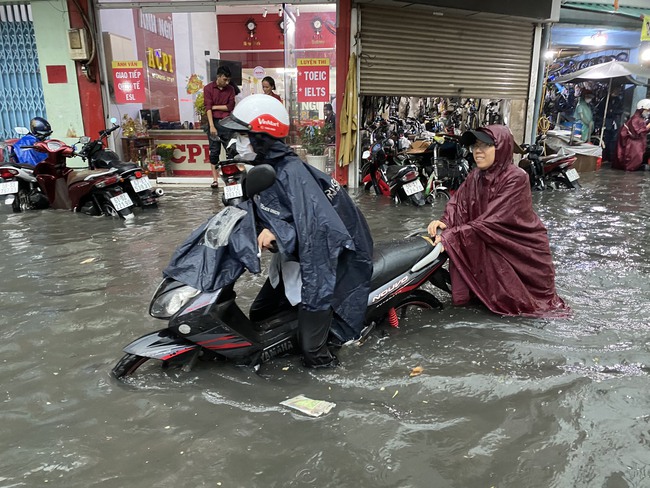 Người dân TP.HCM vật vã dưới trời mưa lớn, nhiều nơi đã ngập - Ảnh 2.