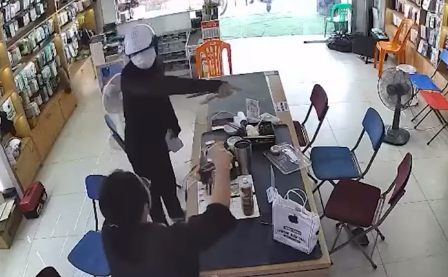Nam thanh niên cầm vật nghi súng và dao để cướp tại cửa hàng điện thoại ở Nghệ An- Ảnh 2.