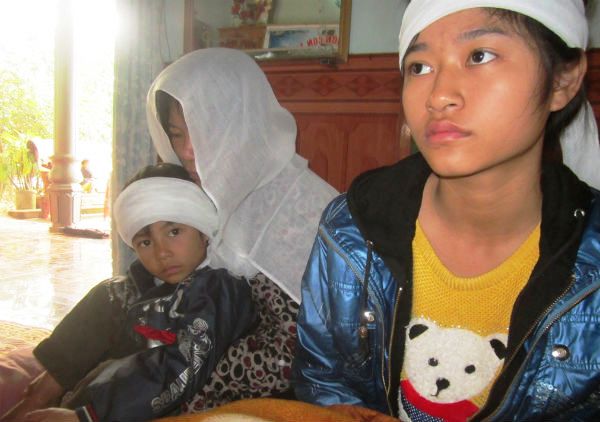 Chị Đặng Thị Điệp cùng 2 con: Sầm Thị Lý (14 tuổi) và Sầm Quang Nhật (5 tuổi) khóc ngất trước bàn thờ anh Sầm Văn Bình.