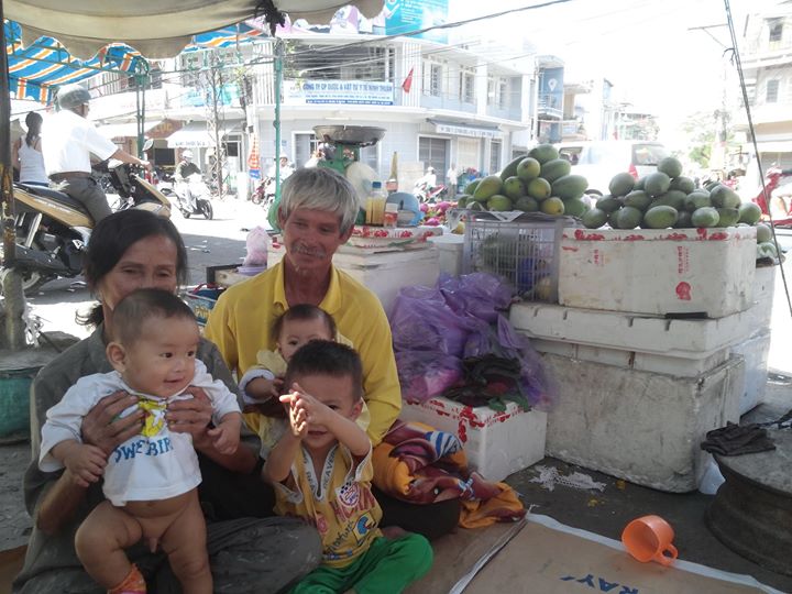 Bé Nguyễn Hồ Duy Khoa (áo trắng), con trai Hồ Duy Trúc khi 4 tháng tuổi tại hàng trái cây ở chợ Phan Rang của bà nội.