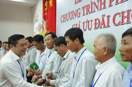 Phó Chủ tịch Hội Nông dân Việt Nam - Ông Lại Xuân Môn (trái) trao sổ cổ đông cho nông dân.