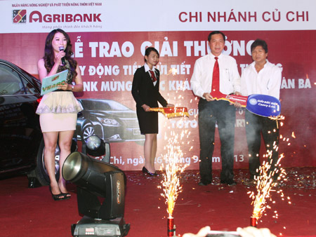 Ông Tiết Văn Thành, Phó Tổng Giám đốc Agribank kiêm Trưởng Văn phòng đại diện khu vực miền Nam (áo trắng bên trái) trao giải đặc biệt cho khách hàng trúng thưởng.
