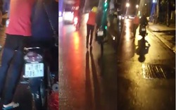 Clip chàng trai dắt xe giữa trời mưa để bạn gái ngồi trên yên gây tranh cãi