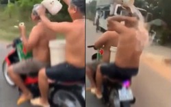 Video hai người đàn ông Việt tắm gội trên xe máy lên báo ngoại
