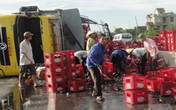 Xe tải chở bia lật nhào, người dân giúp tài xế gom hàng